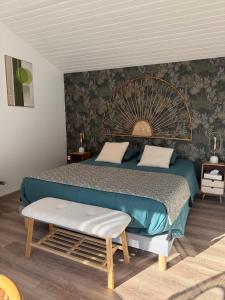 a bedroom with a large bed with a large fan on the wall at INSTANT ZEN in Saint-Vivien-de-Médoc