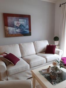a living room with a white couch and a coffee table at Wellnessresidenz "Klaus Störtebeker" App6 in Zingst