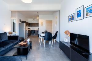 a living room with a couch and a table at Snobby 2-Bedroom Apartment in Larnaca