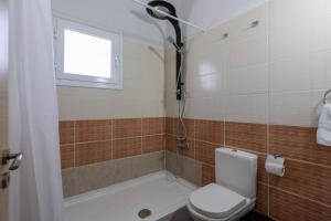 a bathroom with a shower and a toilet and a window at Snobby 2-Bedroom Apartment in Larnaca +8 photos