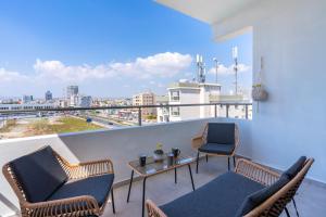 a balcony with chairs and a table and a view at Snobby 2-Bedroom Apartment in Larnaca