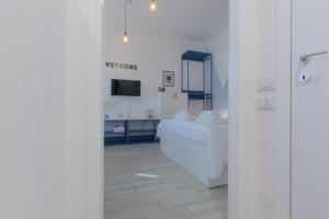 a white room with a bed and a television at Sesto Sky Design - Sesto Rondò in Sesto San Giovanni