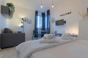 a bedroom with a large bed with towels on it at Sesto Sky Design - Sesto Rondò in Sesto San Giovanni