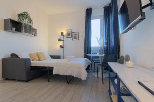 a bedroom with a bed and a couch and a table at Sesto Sky Design - Sesto Rondò in Sesto San Giovanni +10 photos