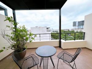 a balcony with a table and two chairs at Lotus Villa Hạ Long in Ha Long