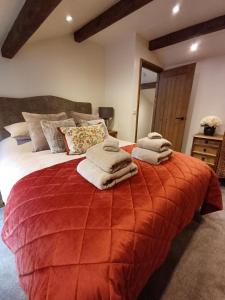 a bedroom with a large bed with towels on it at South view farm cottage 2 Bed in Thornton
