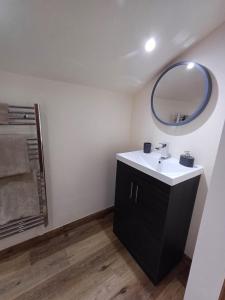 a bathroom with a sink and a mirror at South view farm cottage 2 Bed in Thornton +17 photos