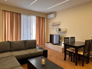 a living room with a couch and a table at Elisabeth Apartments 3 in Sarandë