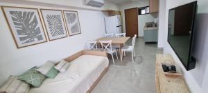 a living room with a couch and a table at Apartamento aconchego Atalaia in Luis Correia