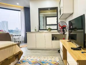 a room with a bed and a desk with a fan at Green Line Long Bien - Serviced Apartment - Ngoc Thuy - Hanoi in Hanoi