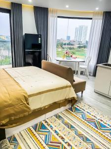 a bedroom with a bed and a living room with a piano at Green Line Long Bien - Serviced Apartment - Ngoc Thuy - Hanoi in Hanoi