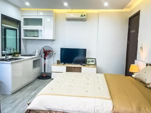 a bedroom with a bed and a kitchen with a sink at Green Line Long Bien - Serviced Apartment - Ngoc Thuy - Hanoi in Hanoi