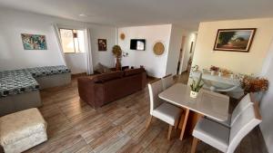 a living room with a table and a couch at Martinelli Residence Beira Mar I e II in Itamaracá