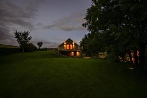 a house with the lights on in a field at Cobstone Cottage in Walmersley