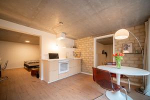 a kitchen and dining room with a table and a room at Stylisches Apartment in Niebüll - Smart TV & WLAN in Niebüll +12 photos