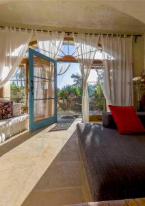 a bedroom with a bed and a large glass door at Farmhouse Dhyana in Għasri