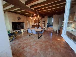 a large living room with a table and chairs at Moulin Rondard in Grézillé