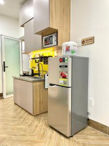 a kitchen with a refrigerator and a counter at Serviced Apartment With High View in Can Tho