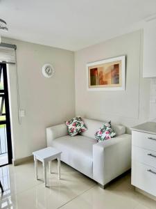 a white living room with a couch and a table at 221 Millennial Umhlanga Ridge in Durban