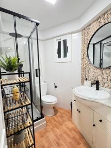 a bathroom with a sink and a toilet and a mirror at UIM Mediterraneo Virgen del Carmen 2 Wifi in Puerto de Sagunto