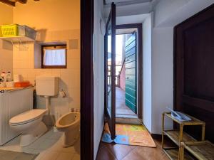 a bathroom with a toilet and a green door at Casa Del Borgo Valpolicella in San Pietro in Cariano +48 photos