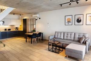 a living room with a couch and a table at Domki Gold-Time Niechorze in Niechorze