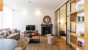 a living room with a couch and a fireplace at Carmo Apartamentos in Porto +13 photos