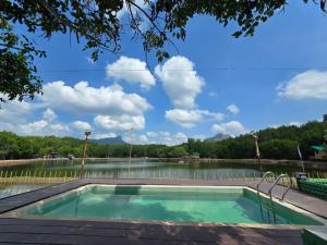 a swimming pool with a view of a lake at Aonang Riverside Home in Ban Khlong Son