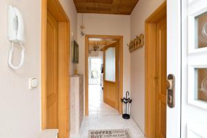 a hallway with a door and a phone on the wall at Bungalow Seestern in Malchow