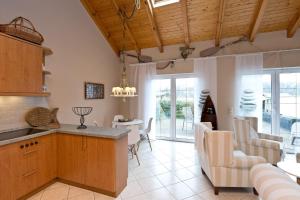 a kitchen and living room with a table and chairs at Bungalow Seestern in Malchow