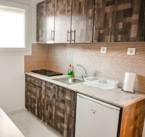 a kitchen with a sink and a counter top at Villa Sonja in Neoi Epivates +5 photos