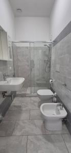 a bathroom with a shower and a toilet and a sink at EremAre casa vacanza in Marina di Massa