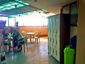 two girls sitting at tables in a school cafeteria at Hostal Sauna Tambo Wasi in Huancayo