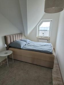 a bedroom with a bed and a window and a table at Studio No 3 in Heinsberg +16 photos