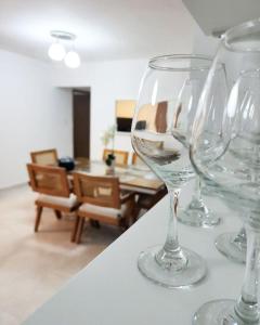 un grupo de copas de vino sentado en la parte superior de un mostrador en Beautiful Accommodation in La Romana Beach View, en La Romana
