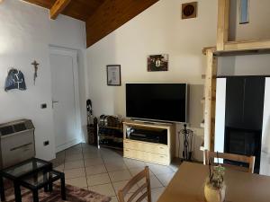 a living room with a flat screen tv on a wall at SISSI MENDEL Residence in Ronzone