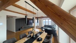 a dining room and living room with a table and chairs at Bergidylle Winkler in Steindorf am Ossiacher See