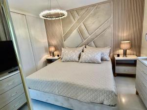 a bedroom with a bed and two night stands at Your Crissere Tropical Dream RD in Punta Cana +27 photos