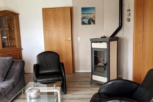 a living room with a couch and a fireplace at Ferienhaus an der Nordsee für 8 Gäste in Wöhrden