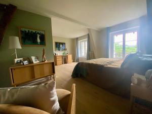a bedroom with a bed and a chair and a window at 2 Chambres, spéciales 24H DU MANS in Le Mans