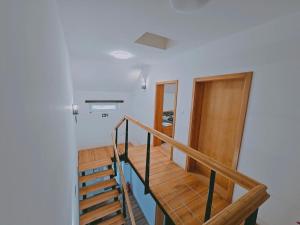 a staircase in a house with wooden floors and a door at Stara škola in Granice