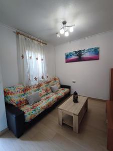 a living room with a couch and a table at Nueva casita de colores in Elche