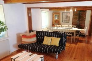 a living room with a couch and a table at Stony in Brösarp