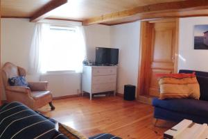 a living room with a couch and a tv at Stony in Brösarp +17 photos