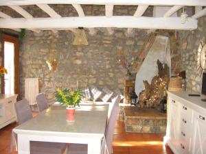 a dining room with a table and a fireplace at Les Genêts in Fayence +44 photos