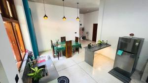 a kitchen and a dining room with a green table at Hey Lala Talalla in Matara