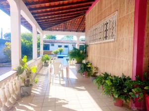 a patio with a table and chairs and plants at Casa de praia in Belém