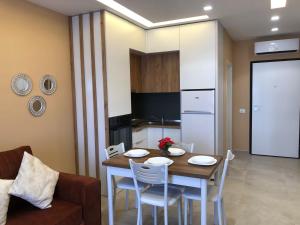 a kitchen and dining room with a table and chairs at Fabio Apartment Qerret in Golem