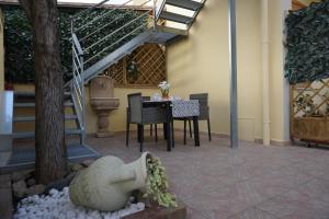 a patio with a table and chairs and stairs at QUARTU SANT' ELENA Casa Stella Marina in Quartu SantʼElena