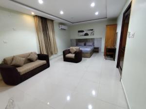 a living room with two couches and a bed at Orcan Room in Al Madinah +7 photos